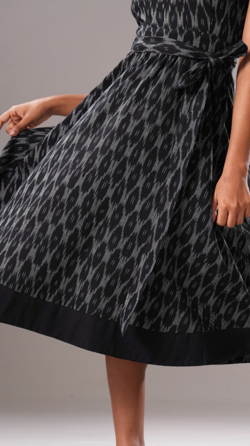 Black and gray patterned dress on a neutral background