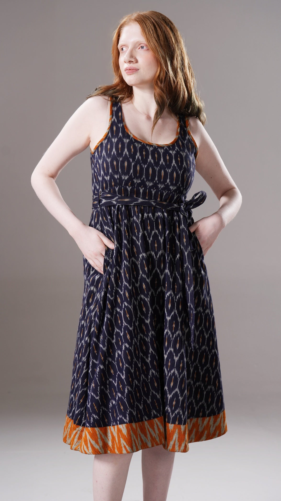 Woman wearing a patterned dress on a plain background