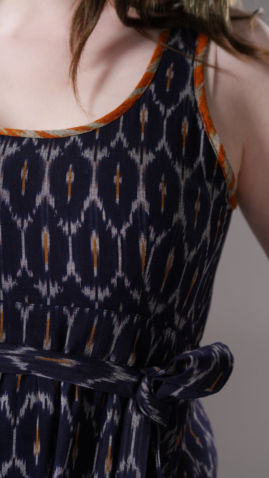 Navy blue dress with white and orange pattern worn by a person