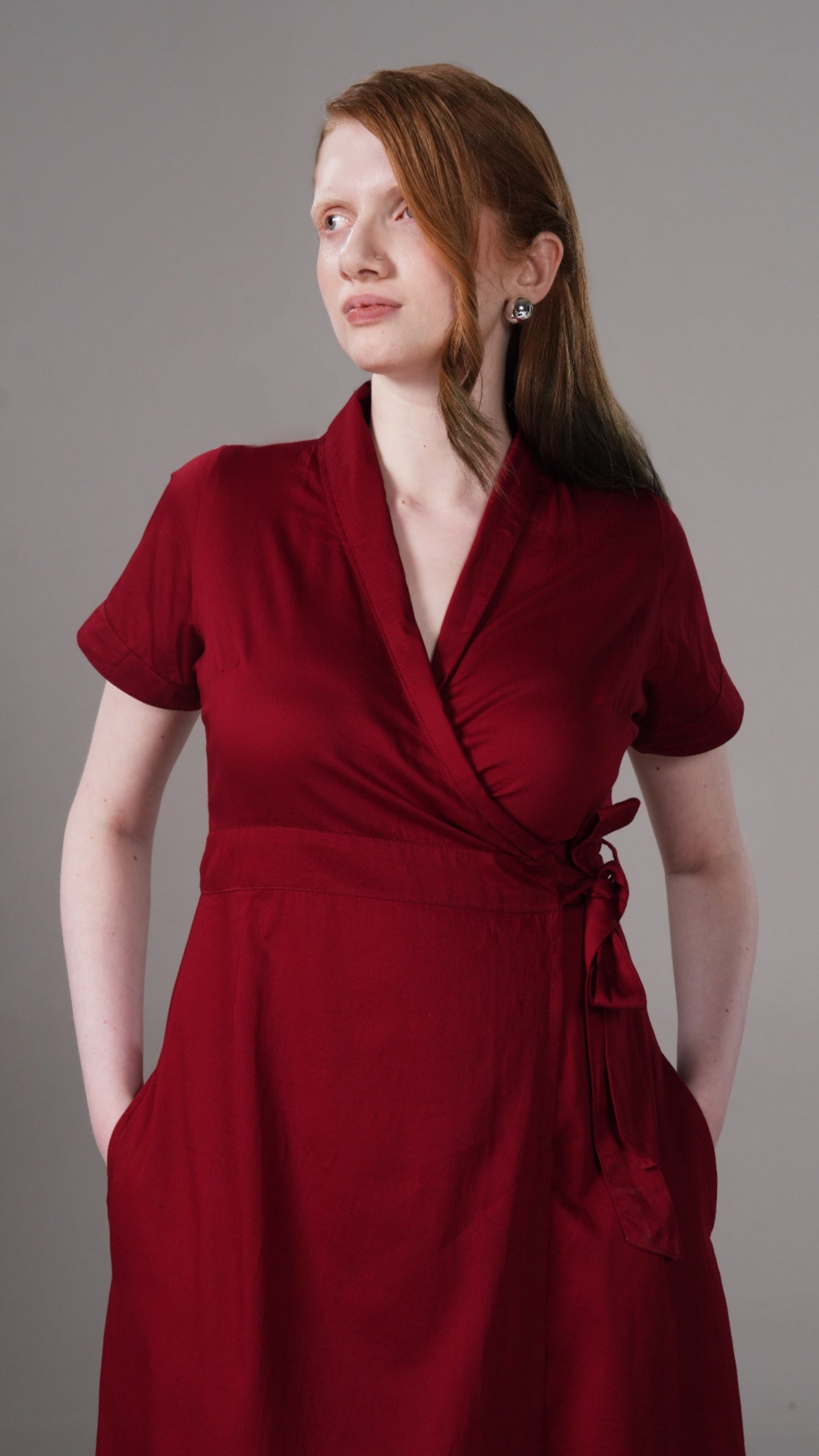 Woman wearing a red dress against a gray background