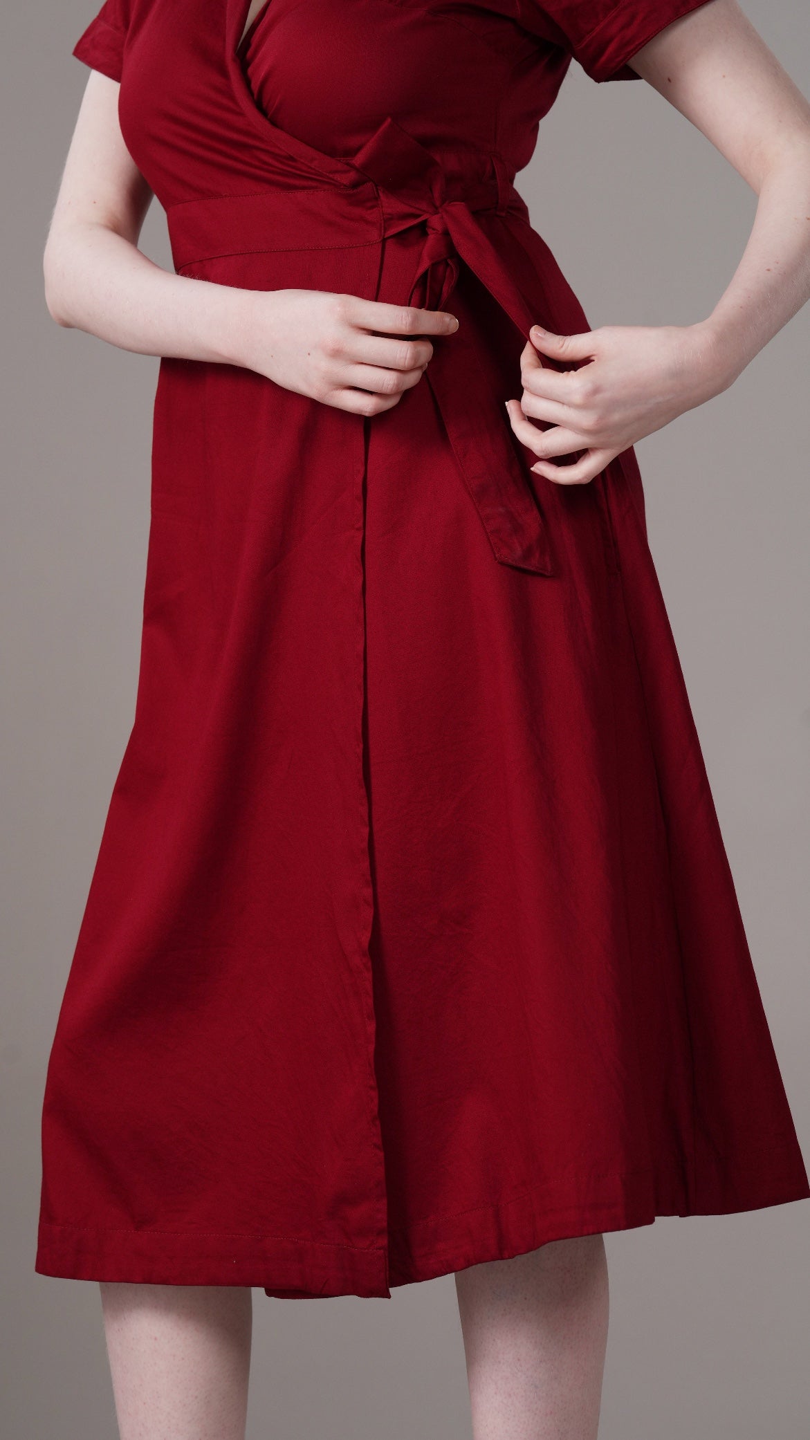 Red dress with a belt on a plain background