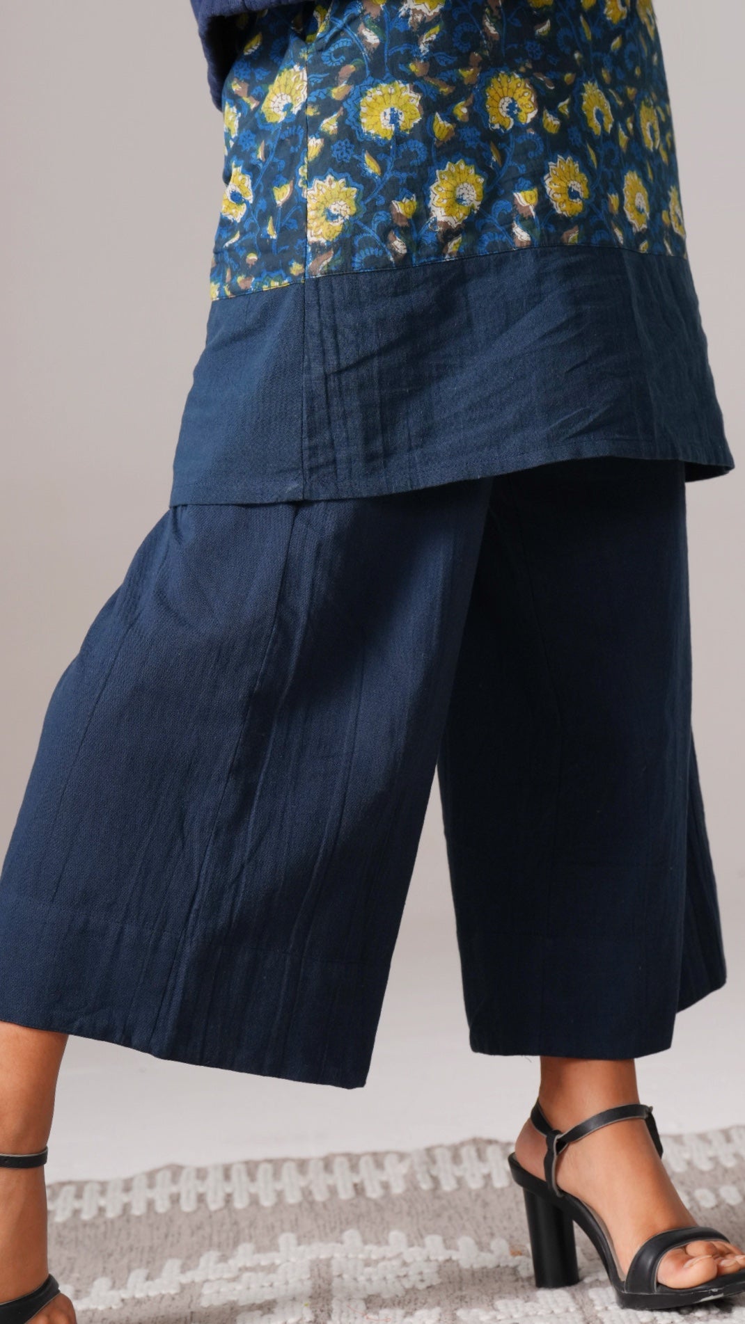 Navy blue floral top and wide-leg pants on a neutral background