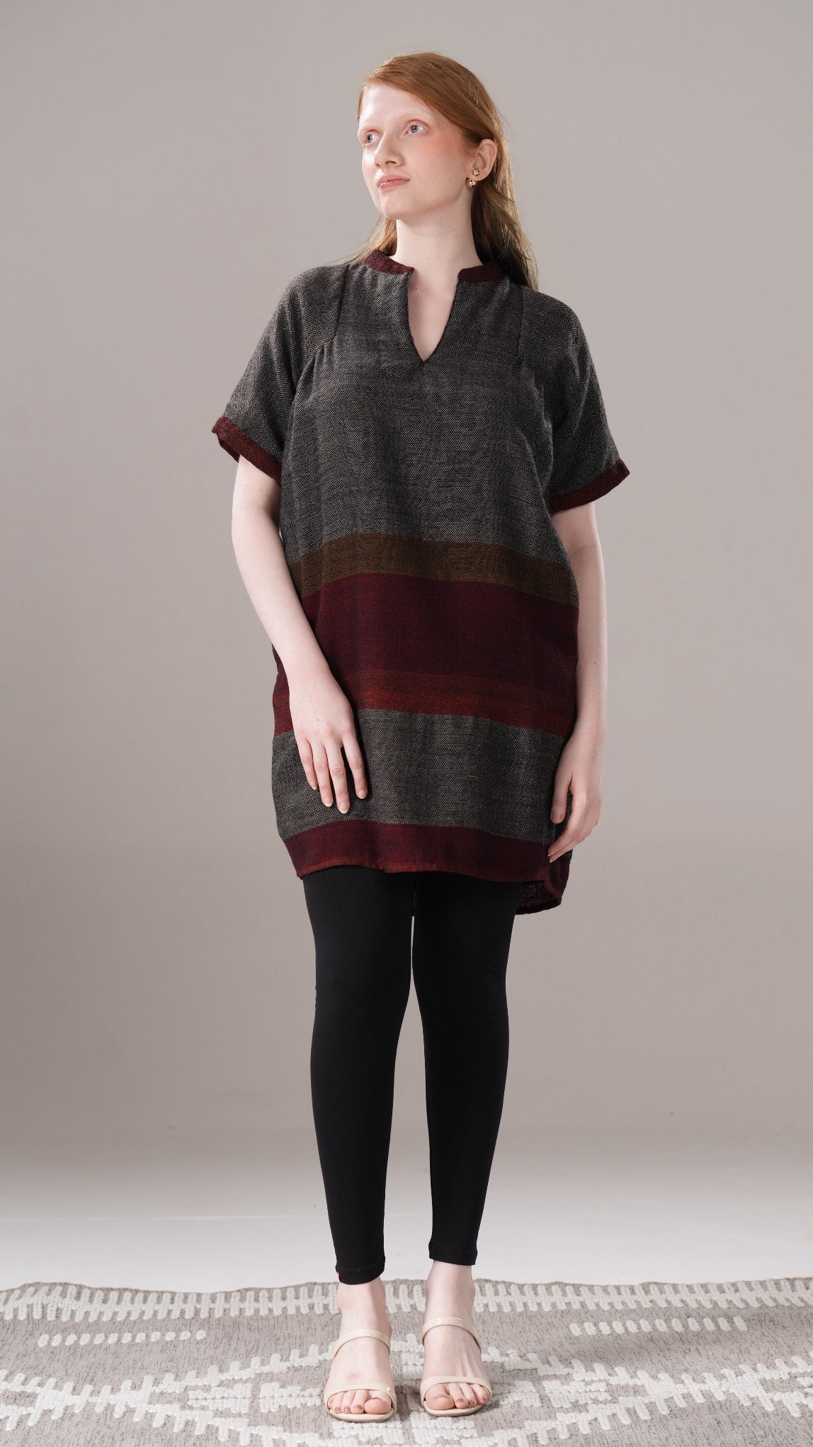 Woman wearing a striped dress with a plain background