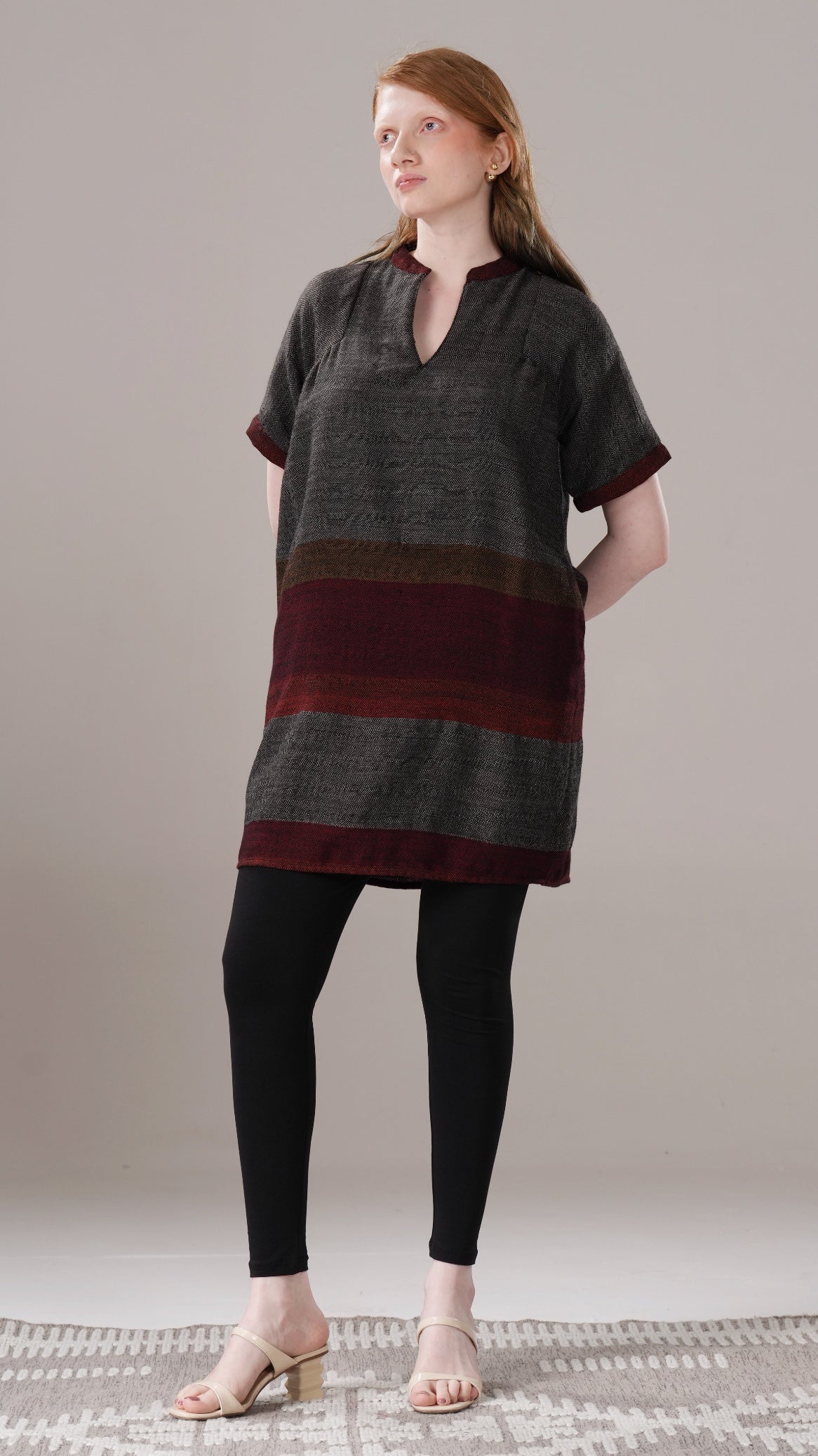 Woman wearing a striped dress with a plain background