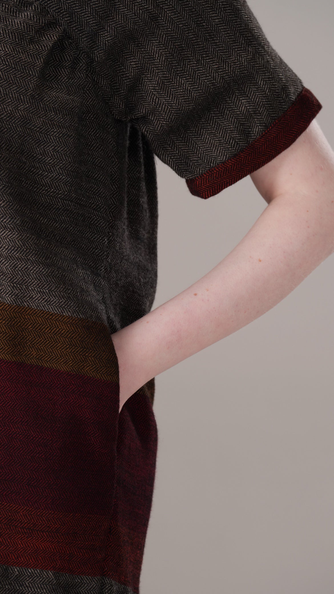 Close-up of a dark brown and maroon garment with a neutral background