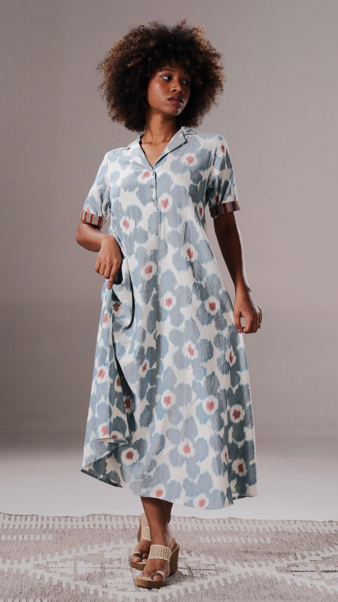 Woman wearing a floral dress on a neutral background