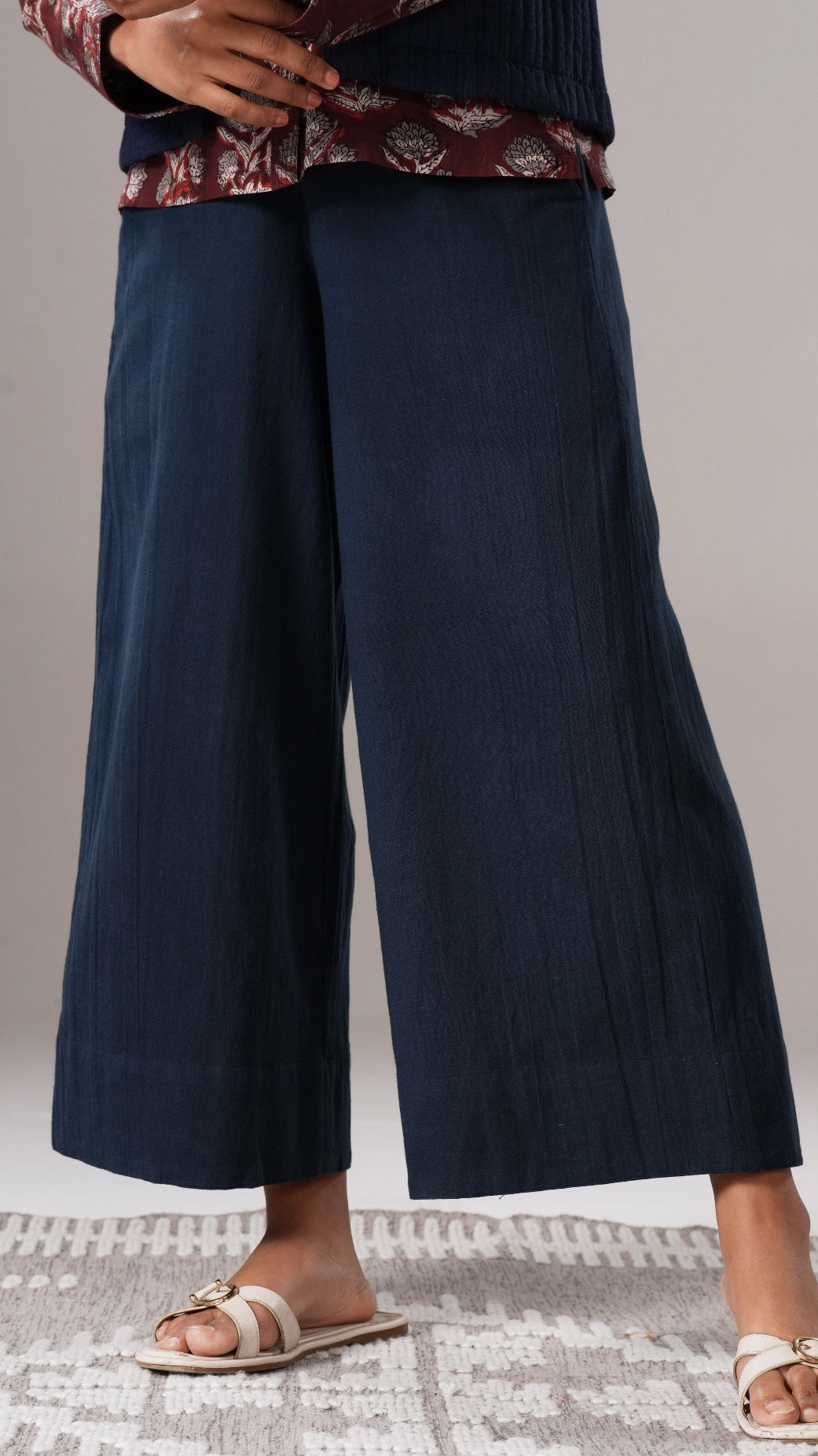 Navy wide-leg pants worn by a person on a neutral background