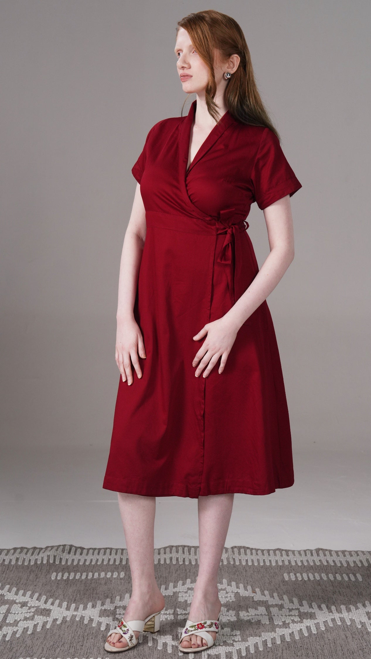 Woman wearing a red dress against a neutral background
